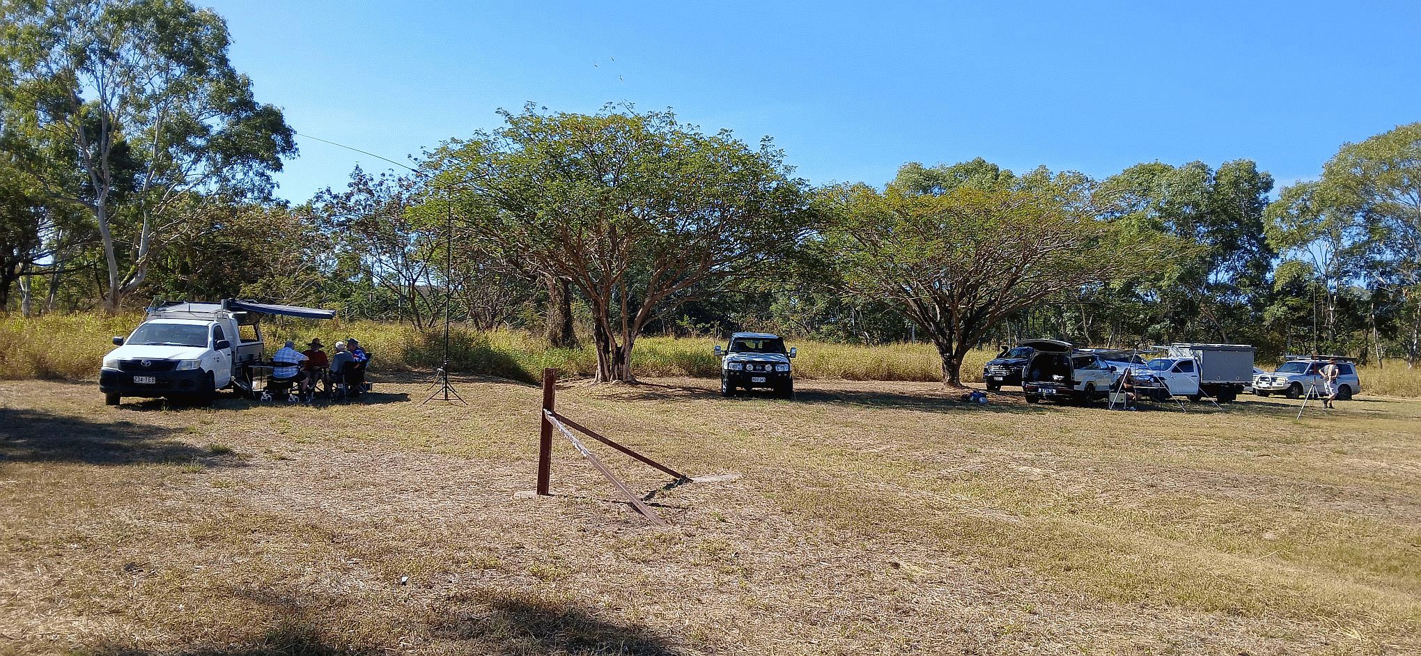 Wide view of the field with vehicles and antenna masts set up