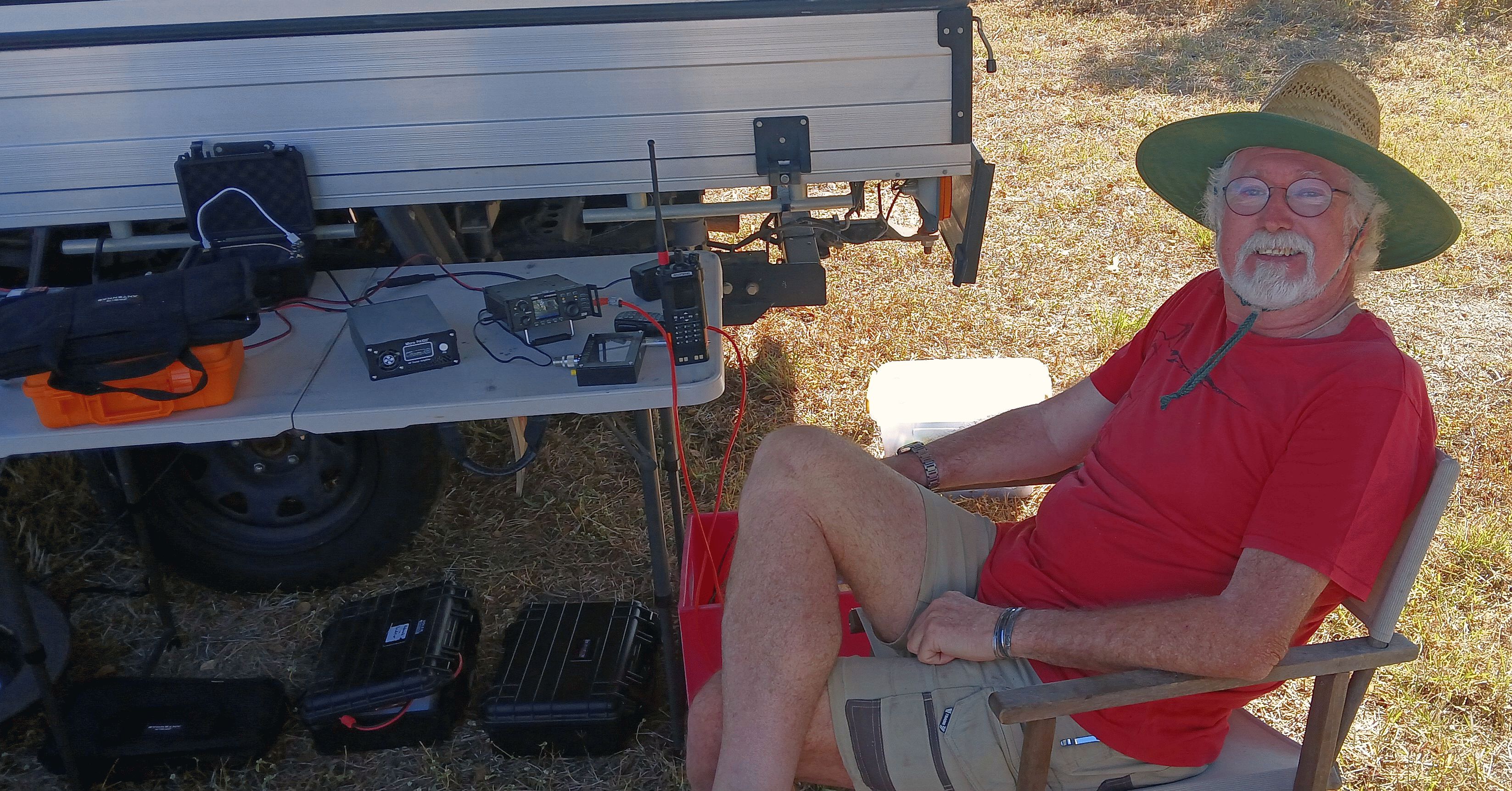 Operator seated at an HF station beside his vehicle