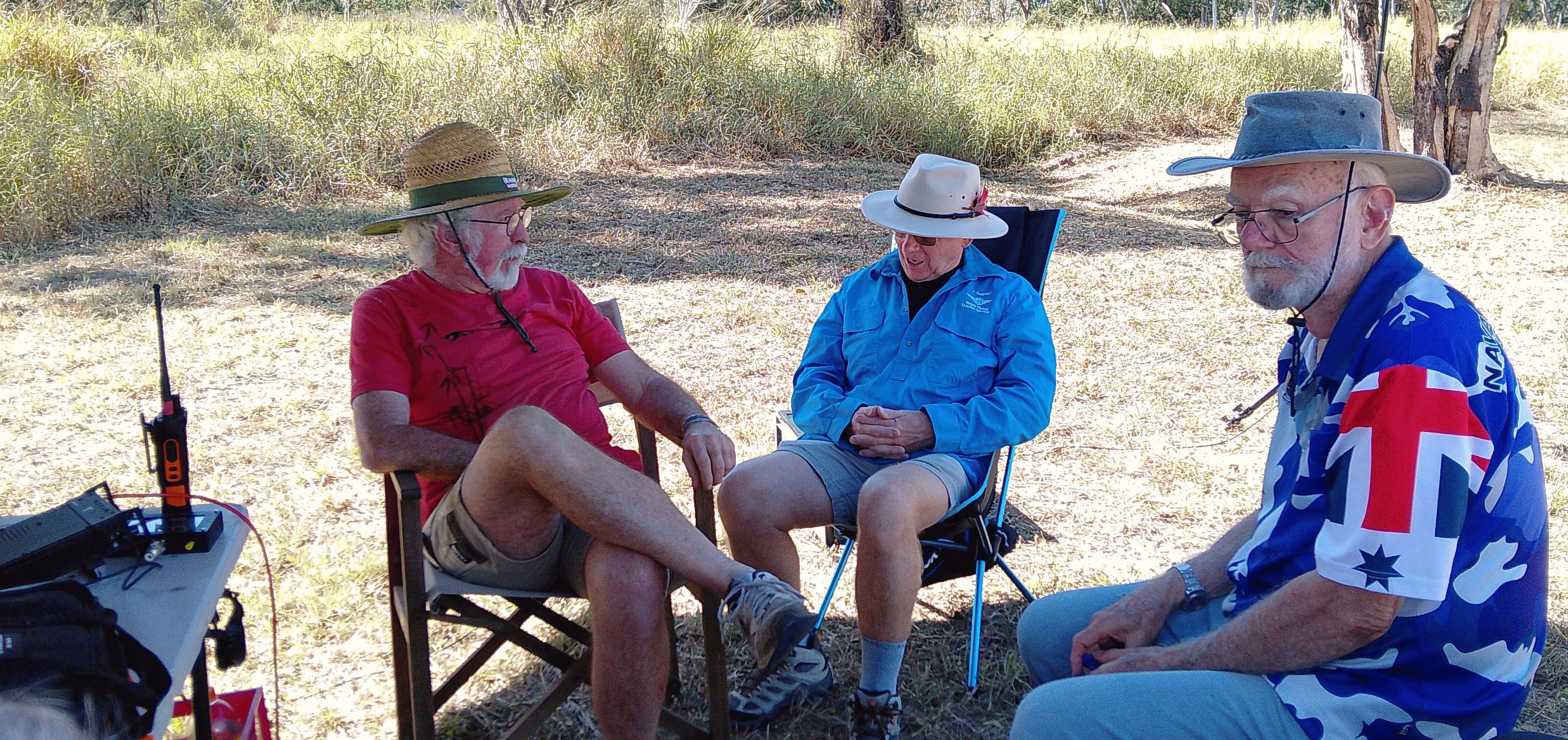 Three members chatting under the shade of trees