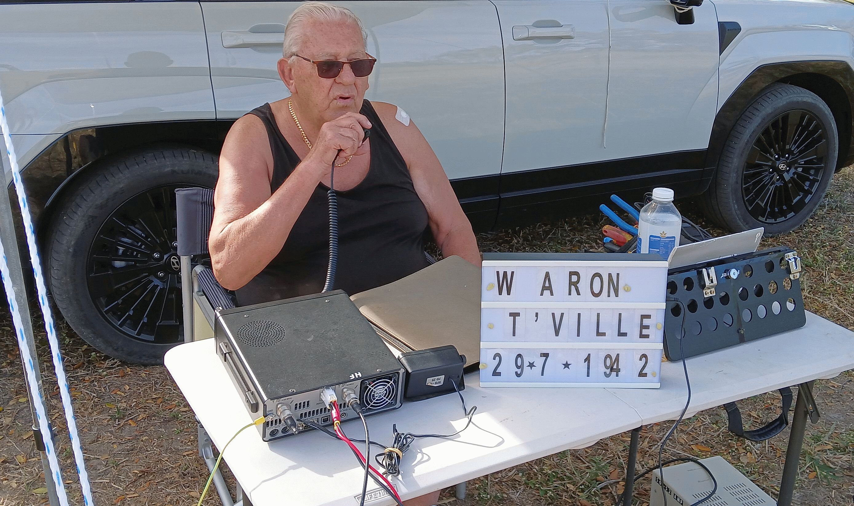 Operator on the microphone beside the WAR ON T'VILLE 29.7.1942 sign