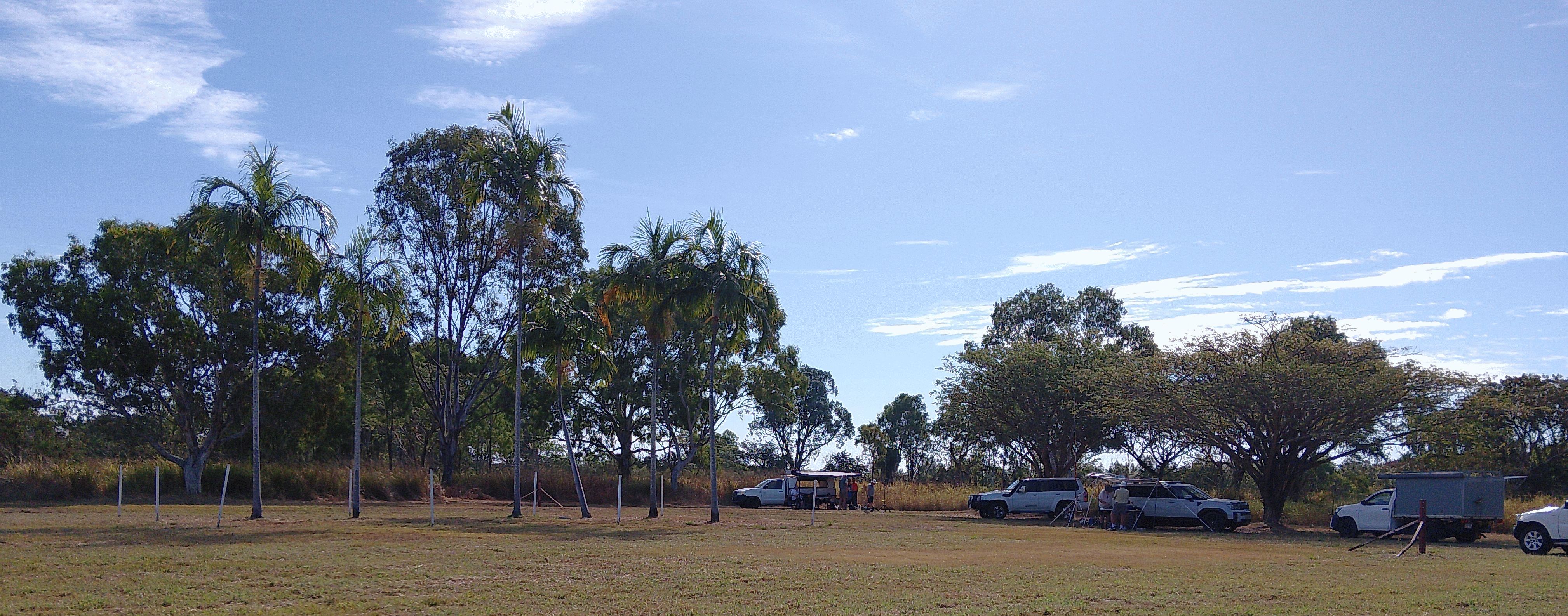 Field stations set up among palm trees at the memorial site