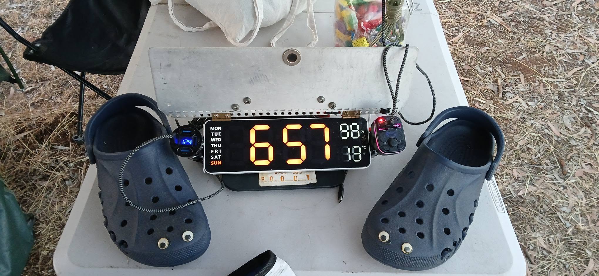 Checkpoint clock reading 6:57 next to googly eyed crocs