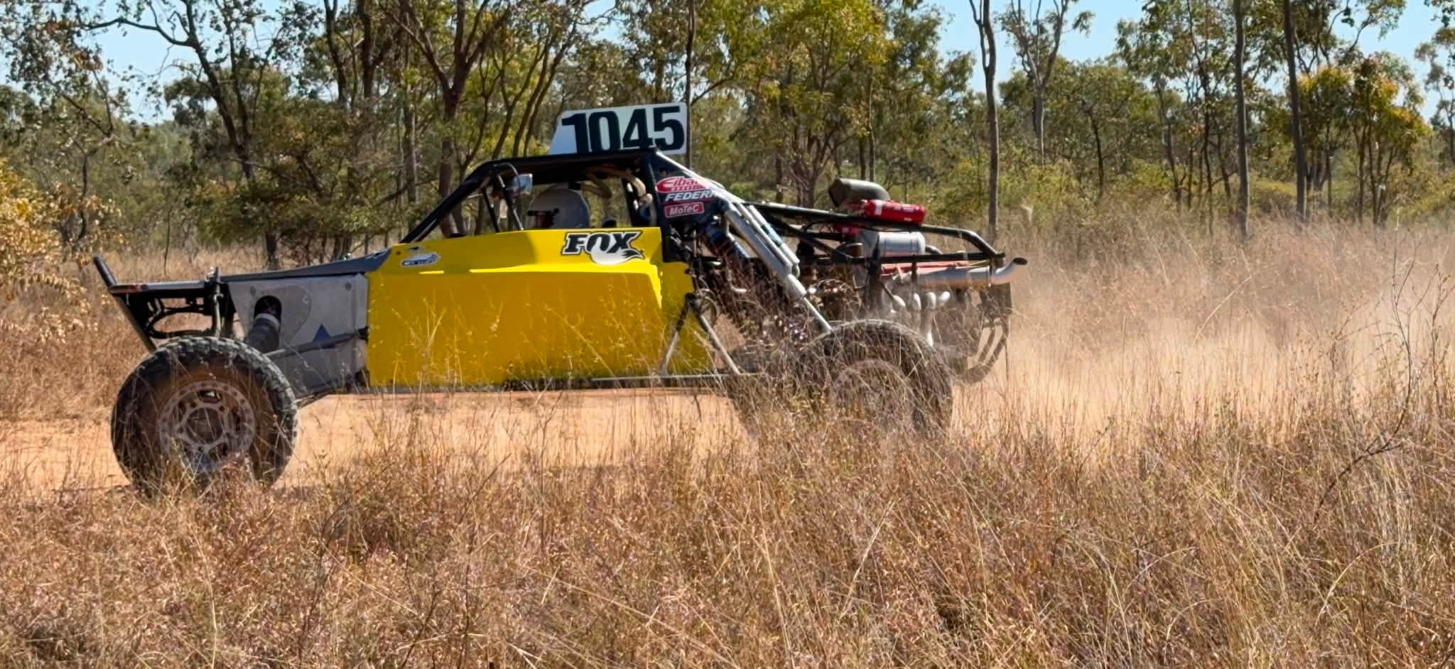 Race car 1045 kicking up dust on the track