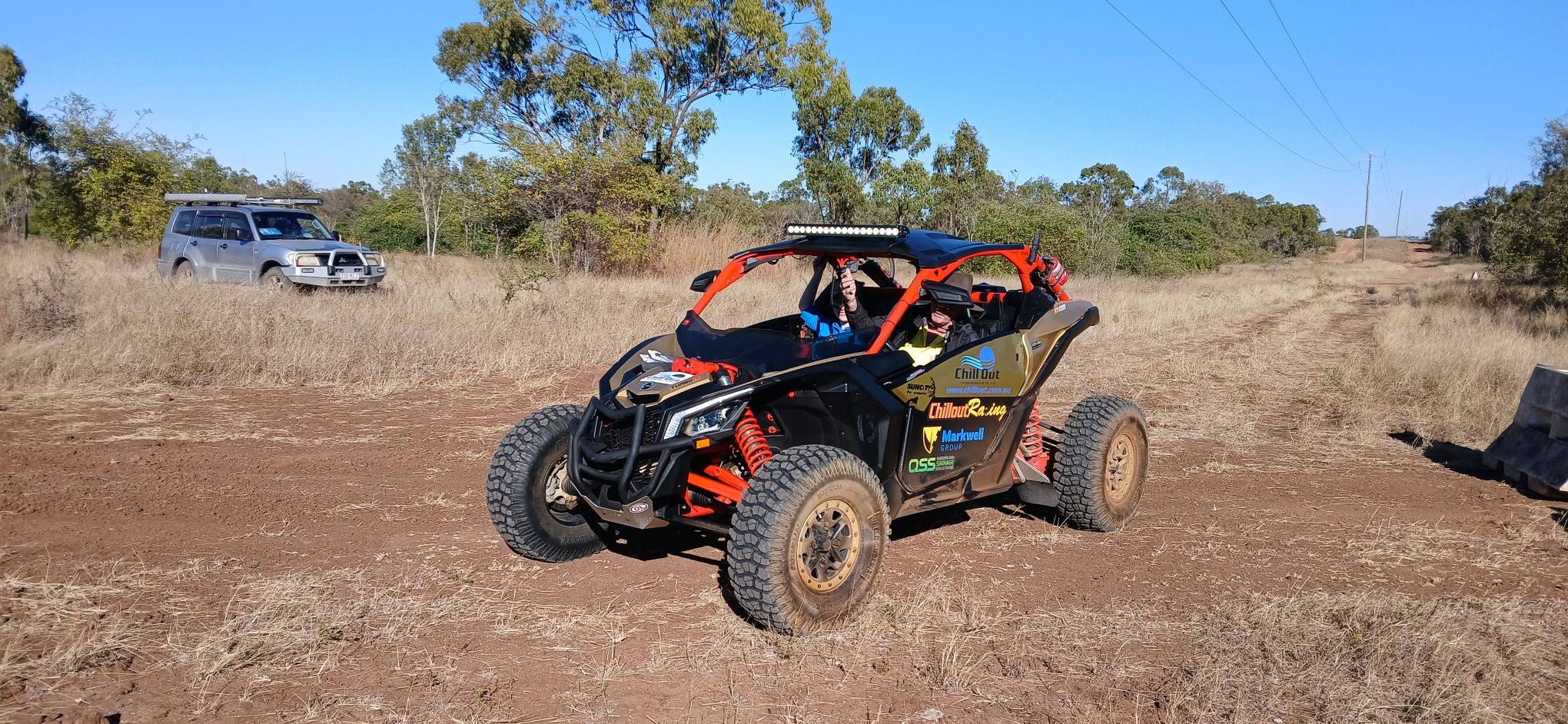 Chillout Racing buggy on the track with support vehicle nearby