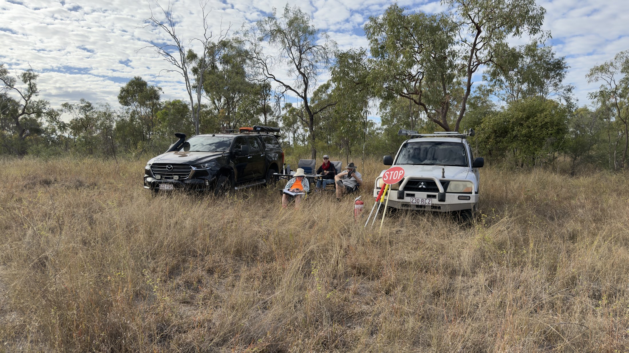 Checkpoint operators with vehicles and a STOP sign