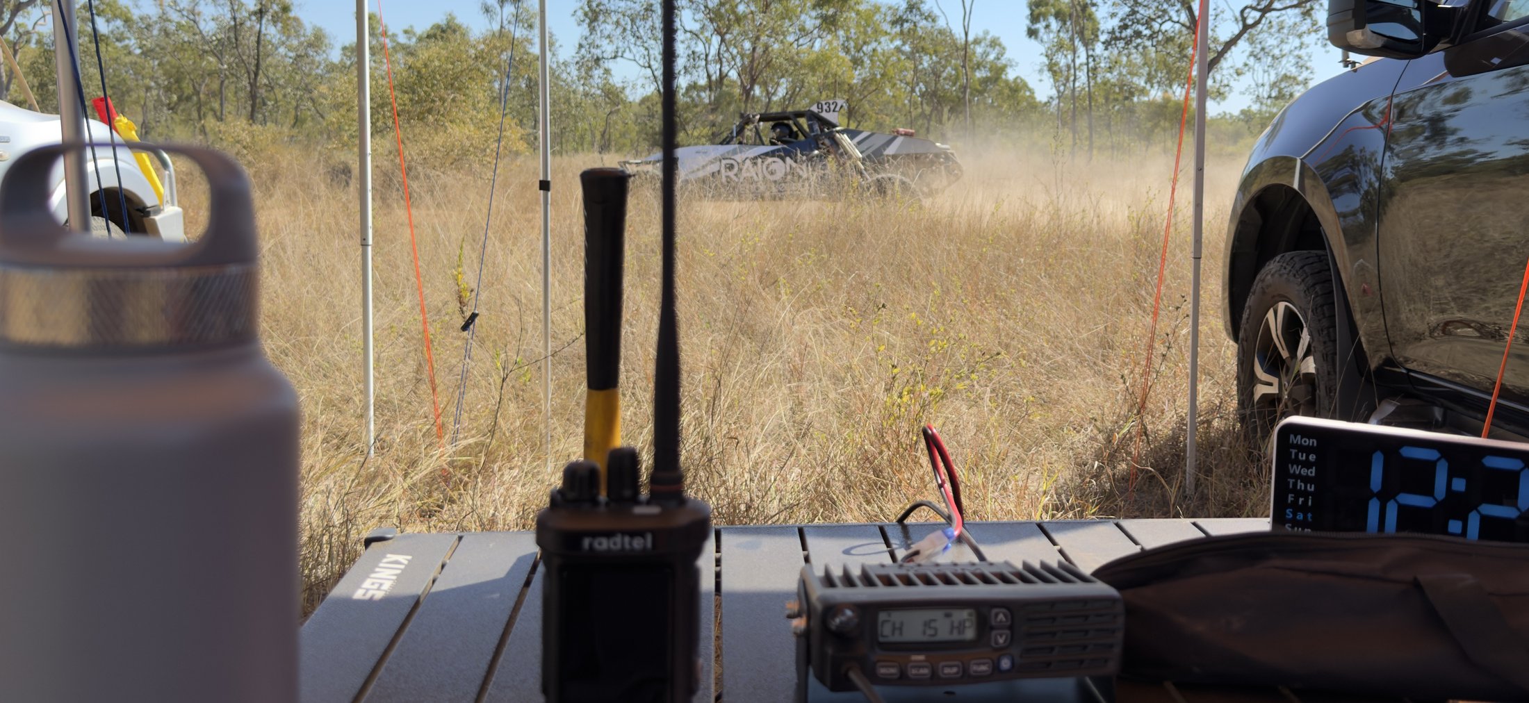 Checkpoint radio table watching a race car pass