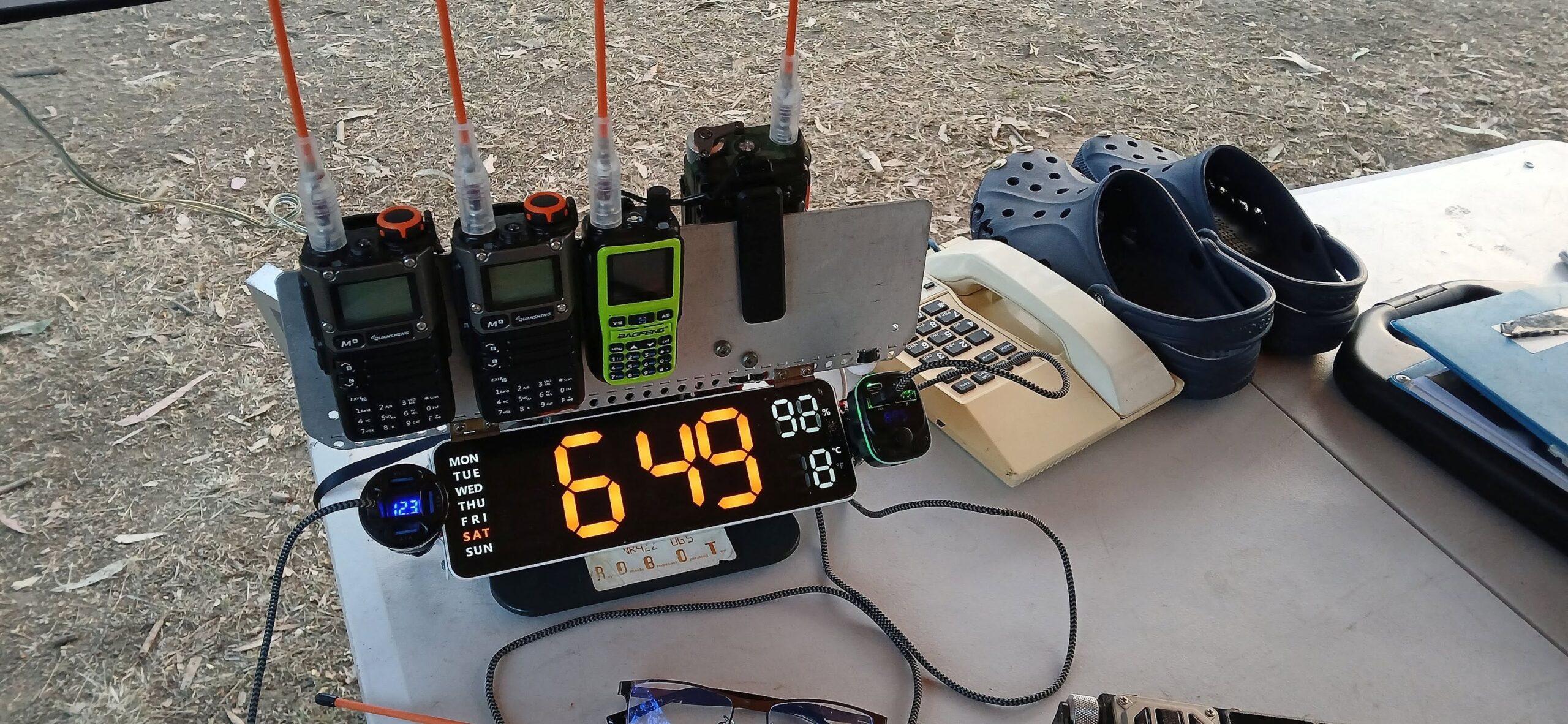 Checkpoint desk with UHF handhelds, phone and the day's countdown clock