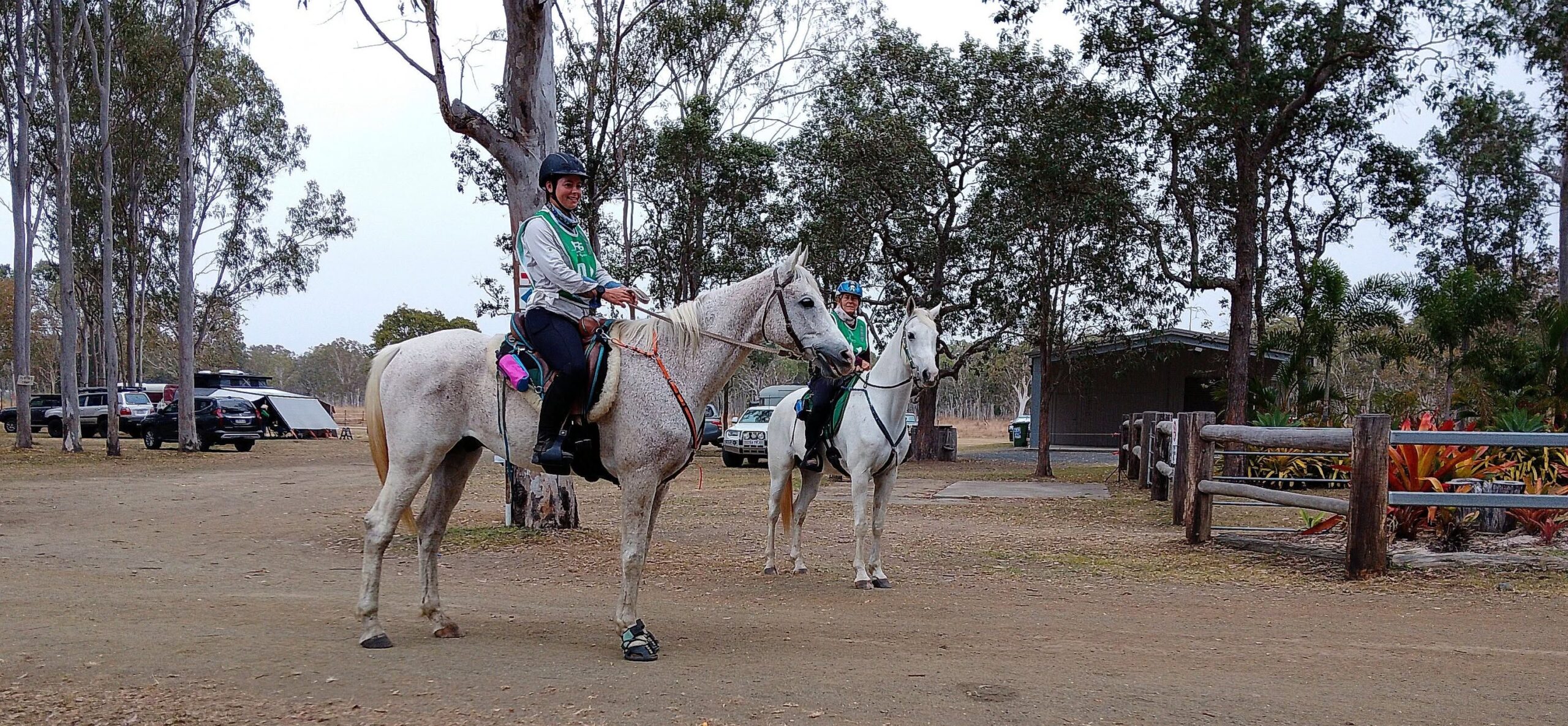 Two young riders on grey horses at the venue