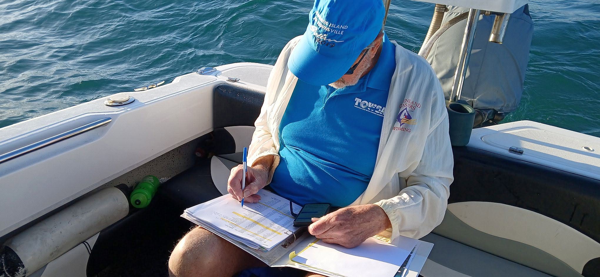 A TOWSA official aboard a rescue boat logging details on a clipboard