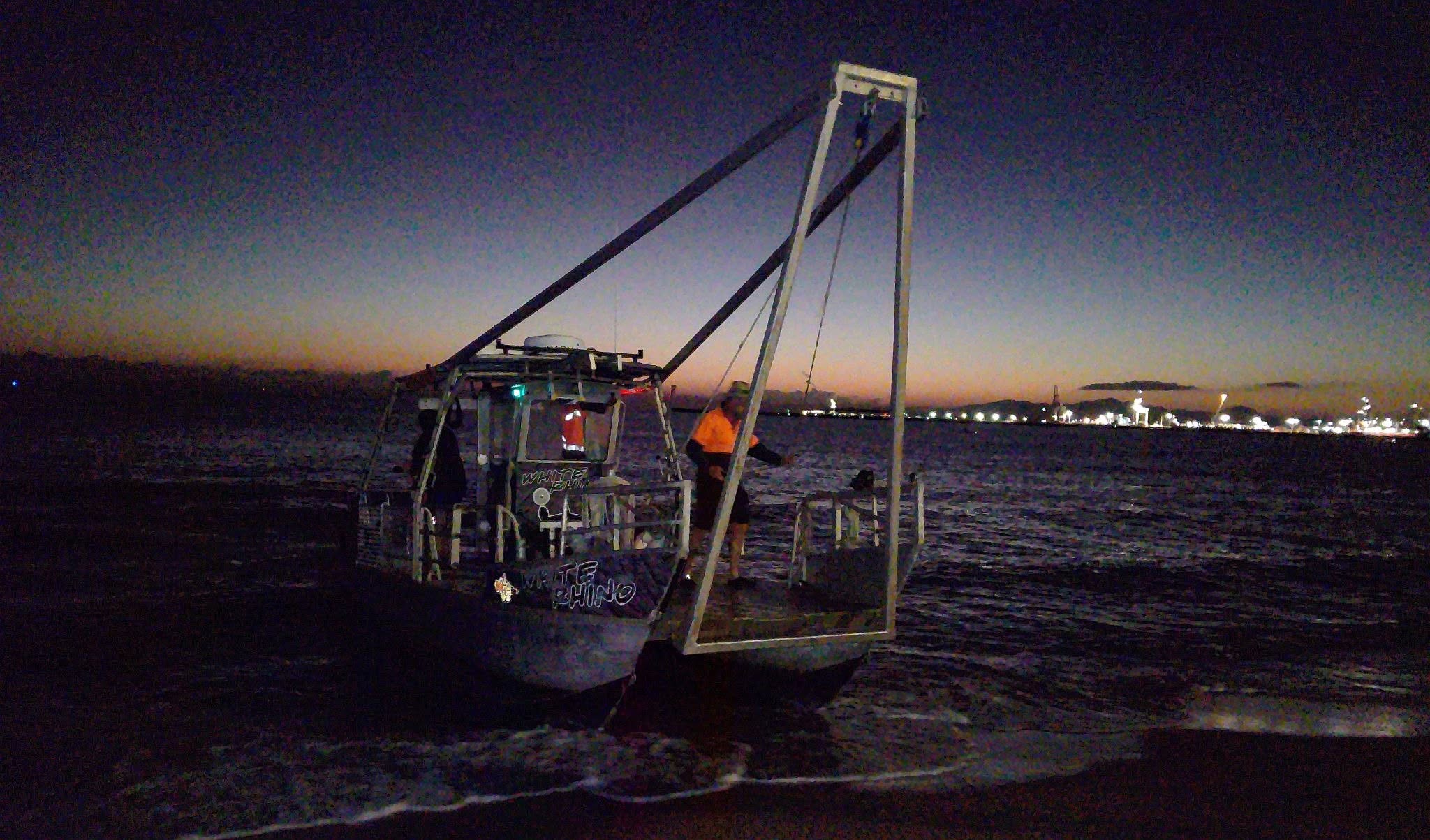 A Rhino Dive work barge beached at dawn, used to ferry sea skiffs to the island