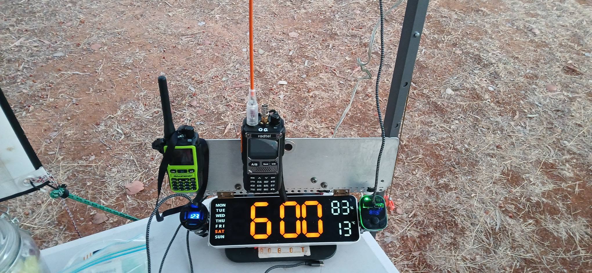 Checkpoint table with UHF handhelds and a digital clock reading 6:00am