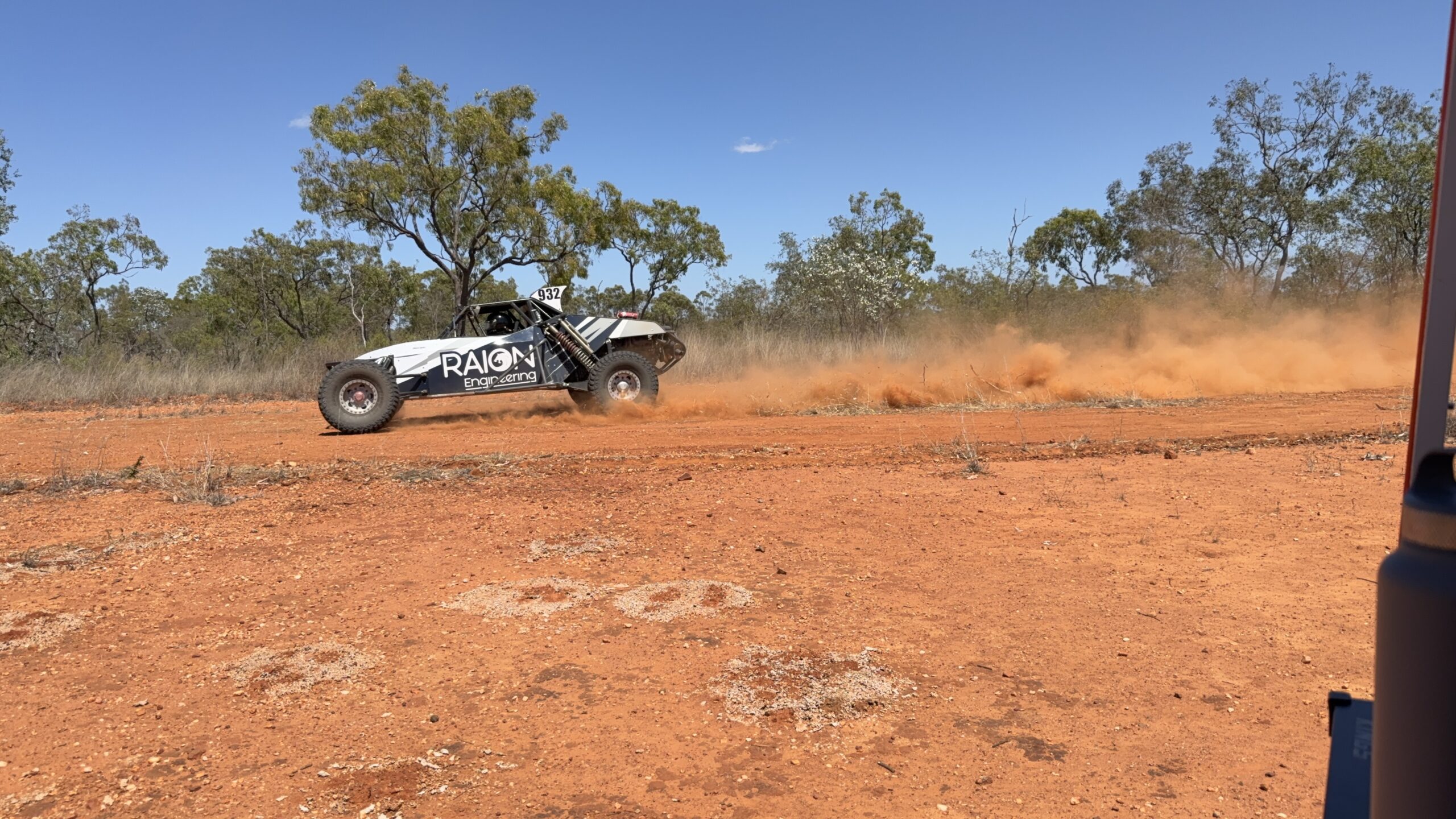 Buggy with Raion Engineering livery sliding through a corner