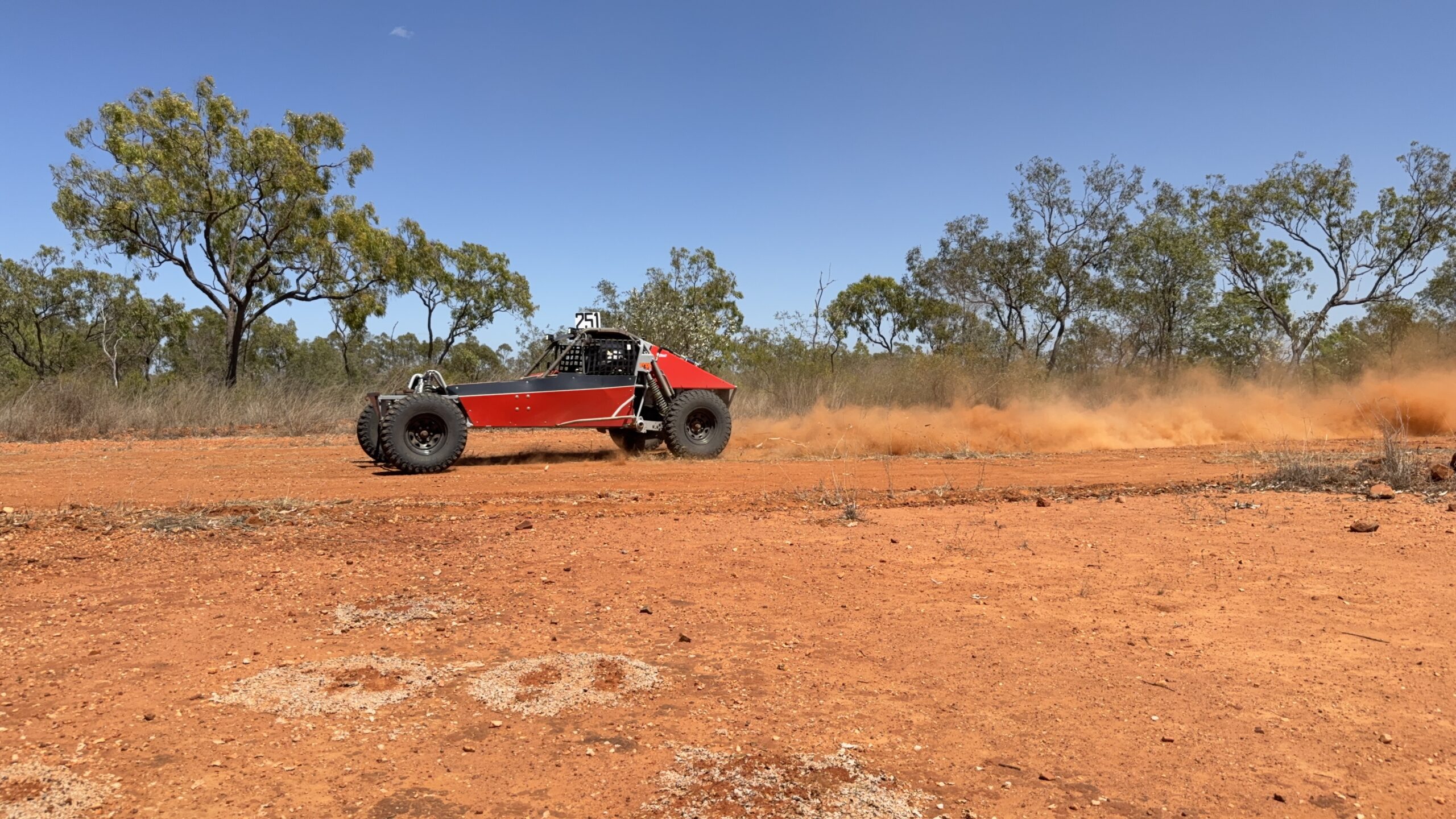Red and black buggy racing past the checkpoint